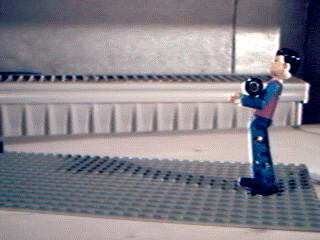 A Lego guy carrying a battery